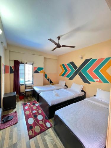 a bedroom with two beds and a ceiling fan at Hotel Everest Lake View in Pokhara