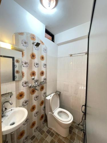 a bathroom with a toilet and a sink at Hotel Everest Lake View in Pokhara