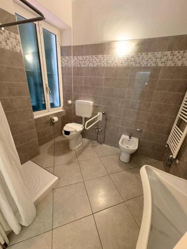 a bathroom with a toilet and a sink at Hotel Gandolfo in Alassio