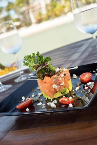 a plate of food on a table with wine glasses at Hotel Casa Hemingway in Juan Dolio