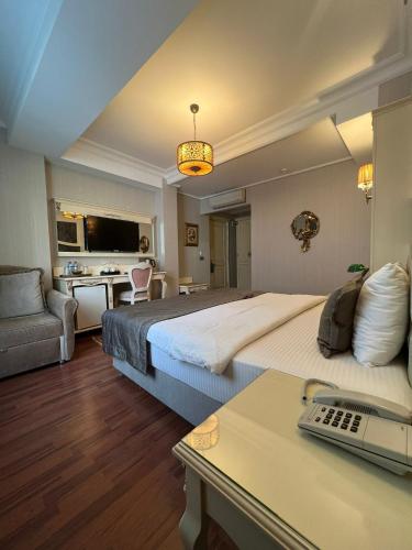 a hotel room with two beds and a desk at Muyan Suites in Istanbul