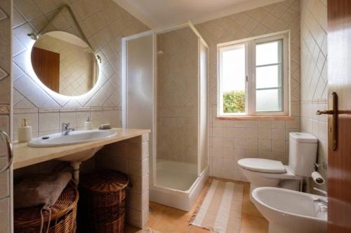 a bathroom with a sink and a shower and a toilet at Casa do Arrozal Comporta in Comporta