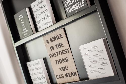 a shelf of books with signs on it at Clouds Estate in Stellenbosch