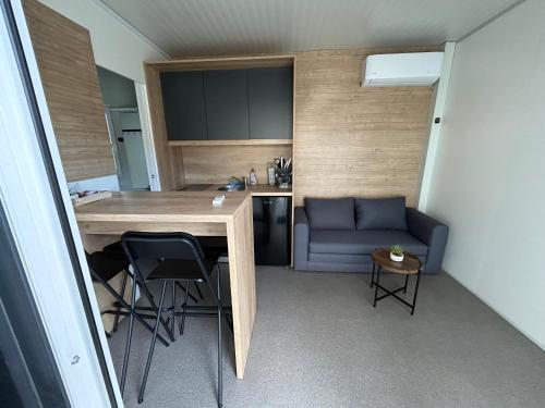 a room with a table and chairs and a couch at Tiny homes ŠMARNA in Ljubljana