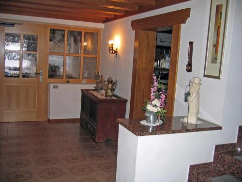 a room with a kitchen with a counter and a door at Pension Thalerhof in Rifiano