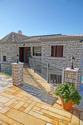 a house with a wooden deck with a fence at Treanto Nafpaktos Boutique Hotel in Nafpaktos