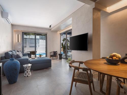 a living room with a couch and a table at Grand Residences in Chania