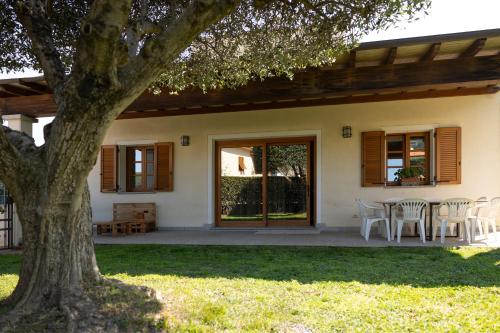 a house with a patio and a table and chairs at Villa Libo - HelloElba in Marciana Marina