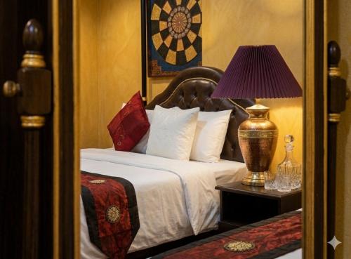 a bedroom with a bed with a lamp on a table at Chaba silom in Bang Rak