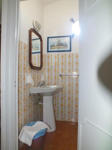 a bathroom with a sink and a mirror at Locanda Laudomia in Manciano