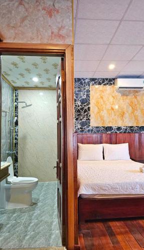 a bedroom with a bed and a bathroom with a toilet at Hotel View Sông Phú Quốc in Phú Quốc