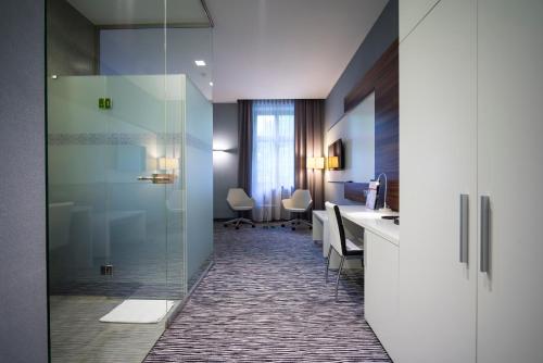 an office with a reception desk and a glass door at Hotel Gorczowski Katowice Chorzów in Chorzów
