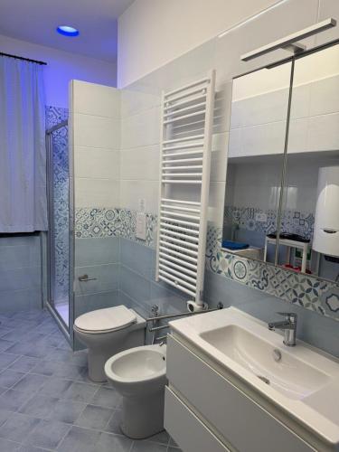 a white bathroom with a toilet and a sink at Vietri House 88 in Vietri sul Mare