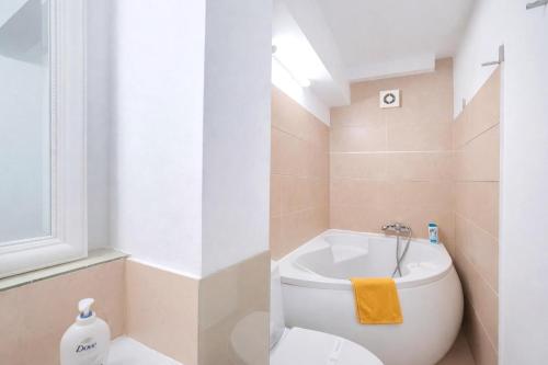 a bathroom with a toilet and a sink at Victoriei Boutique Apartment in Bucharest