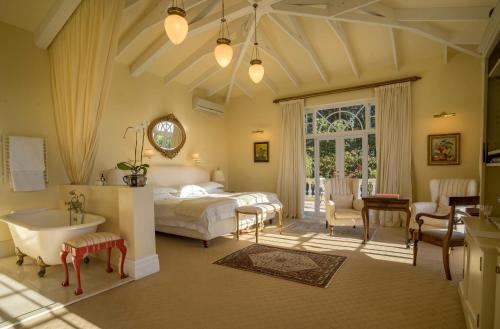 a bedroom with a bed and a desk and a sink at Colona Castle in Lakeside