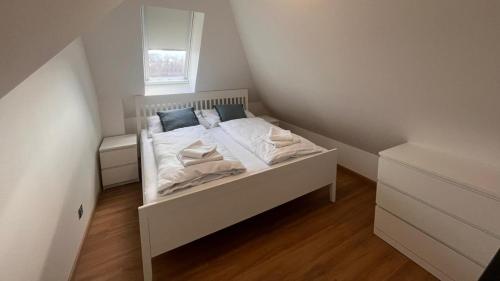 a small white bed in a small room at Ulrichova vila a Vilka Rejhotice in Šumperk