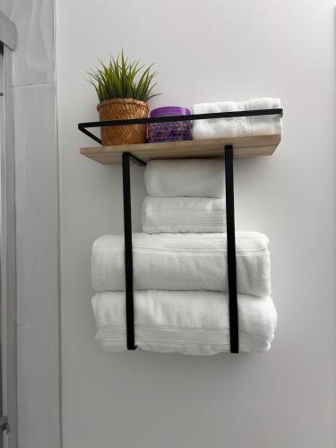 a stack of towels on a shelf in a bathroom at Elevated Horizon Retreat in Chilliwack