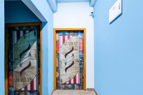 two doors with stained glass windows on a building at Hotel O Blue Valley in Khandagiri