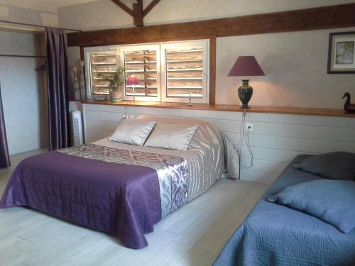 a bedroom with a bed and a window at Le Logis Du Four in Soudan