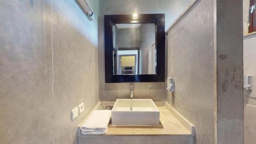 a bathroom with a sink and a mirror at Villa Agapanthe in Fez