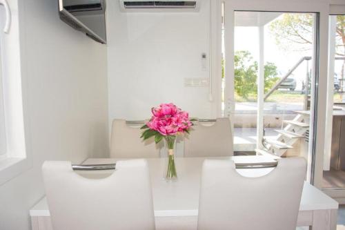 a vase of pink flowers sitting on a table at Floating house - Marina Relax in Portorož