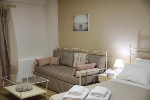a living room with a couch and a bed at Treanto Nafpaktos Boutique Hotel in Nafpaktos