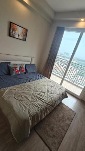 a bedroom with a bed and a large window at Romaer's Room in Greater Noida