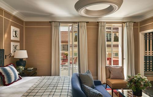 a bedroom with a bed and a large window at Rocco Forte The Carlton in Milan
