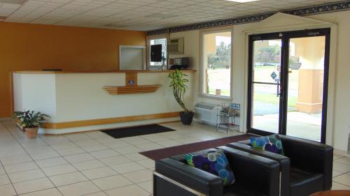 a living room with two couches and a counter at Oceanside Lodge in Marmora