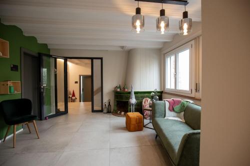 a living room with a couch and a table at Résidence Bellevue - Hôtel et Studios in Charmey