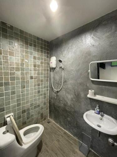 a bathroom with a shower and a toilet and a sink at The Smoke Shop in Ban Suan