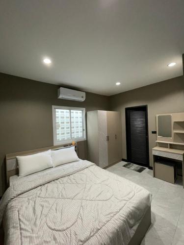 a bedroom with a large bed and a sink at The Smoke Shop in Ban Suan