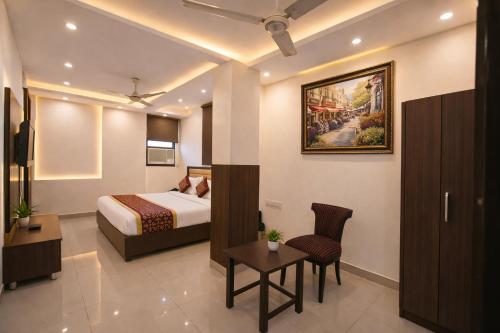 a hotel room with a bed and a table at Mauryan Elite Hotel Vasant Kunj in New Delhi