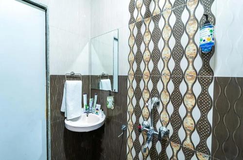 a bathroom with a sink and a mirror at Kaizen Stays And Resto in Panchgani