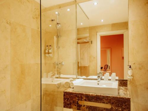 a bathroom with a sink and a shower at Topazio Vibe Beach Hotel & Apartments - Adults Friendly in Albufeira