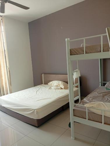 a bedroom with two bunk beds and a window at Alpha 2 in Johor Bahru