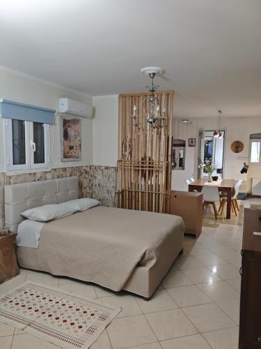 a bedroom with a bed and a dining room at Villa Maxim in Corfu Town in Corfu