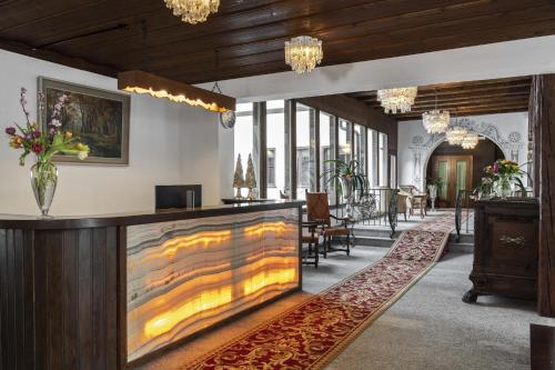 a lobby with a large painting on the wall at Hotel Bad Serneus in Klosters