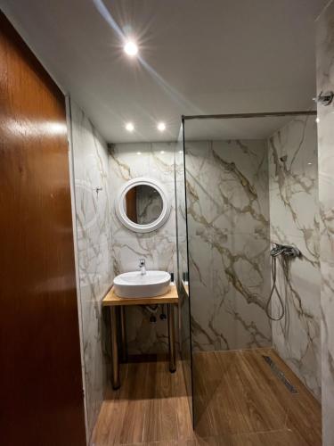 a bathroom with a sink and a mirror at Premium ikaros in Laganas