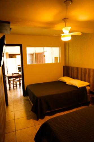 a bedroom with a bed and a ceiling fan at Casas 1 Terrace in Laguna