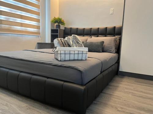 a large bed with a black tufted headboard at Casita Luna in San Juan