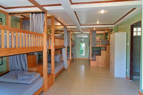 a hallway with bunk beds in a house at Chalok Reef Divers Hostel in Ko Tao