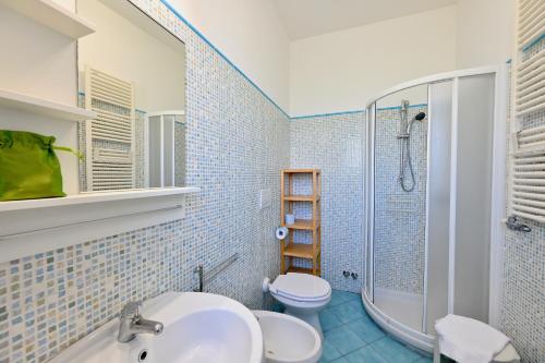 a bathroom with a sink and a toilet and a shower at Don Giorgio Studios in Ischia Town