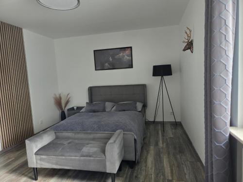 a bedroom with a bed and a couch at Ferienwohnung Lux in Ortenberg