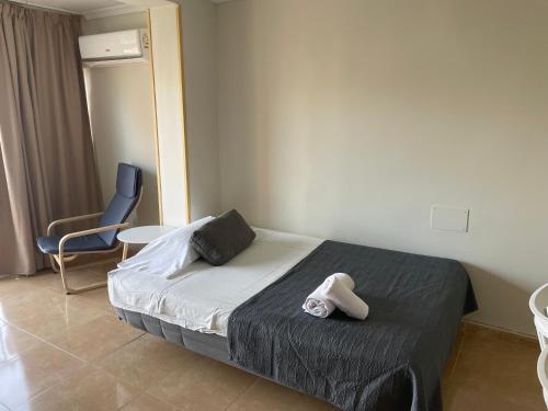 a hotel room with a bed and a chair at BERMUDAS-TURIS Apartamentos in Benidorm