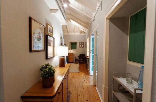 a room with a hallway with a table and a lamp at Hotel Casa da Nora in Leiria