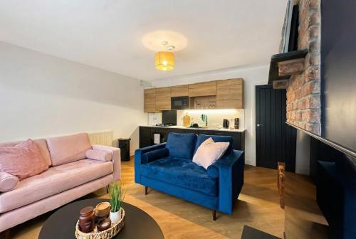 a living room with a couch and a table at Brontë Country 4 Bed Retreat with Fireplace in Oakworth