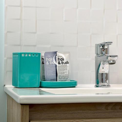 a bathroom sink with two products sitting on it at GC - La Voile Bleue in Wissant