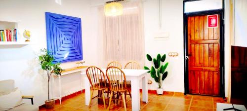 a dining room with a white table and chairs at Casa Playa Moncofa in Moncófar