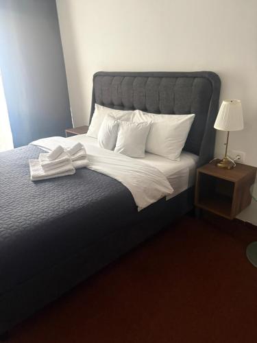 a bedroom with a large bed with white sheets and pillows at hotel Diana in Murska Sobota